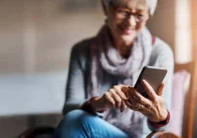 Elderly woman holding cell phone